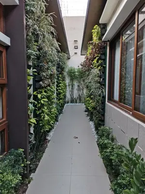 a walkway in the middle of a building with plants at Adria Residences - Sapphire Garden - 2 Bedroom for 4 person in Manila