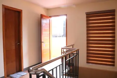 a staircase with a wooden door and a window at Anicia Guesthouse Units in Manila
