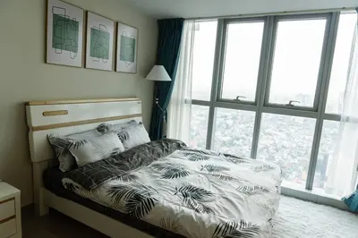 a bedroom with a bed with a large window at A2J Luxury 3BR Uptown Balcony BGC Suite Near Mall in Manila