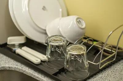 a blow dryer and glasses on a shelf in front of a mirror at Uptown Parksuites Modern Room in Manila