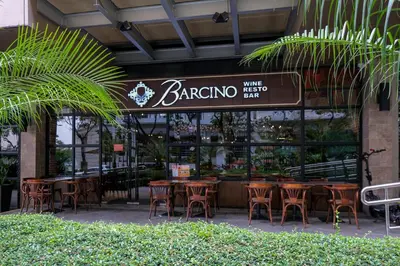a restaurant with tables and chairs in front of a building at Uptown Parksuites Modern Room in Manila