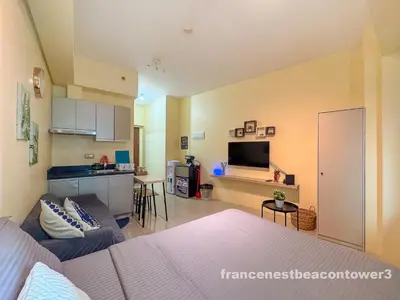 a living room with a bed and a kitchen at Modern Condo Living in Makati in Manila