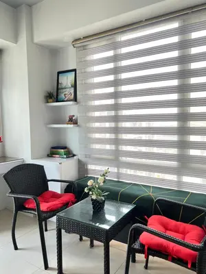 a living room with a couch and chairs and a table at Condotel Across Naia Airport with WIFI in Manila