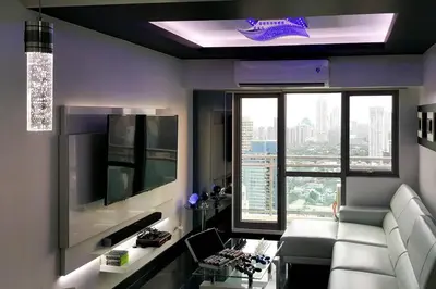 a living room with a white couch and a tv at 2BR Lower Penthouse @ Acqua Private Residences in Manila