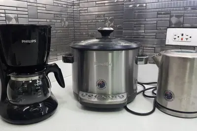 a slow cooker and a coffee maker on a counter at 2BR Lower Penthouse @ Acqua Private Residences in Manila