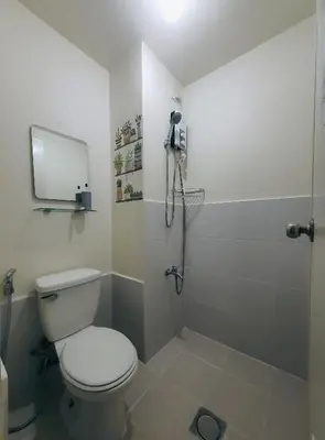 a bathroom with a toilet and a shower at Urban Deca Shaw EDSA Mandaluyong in Manila