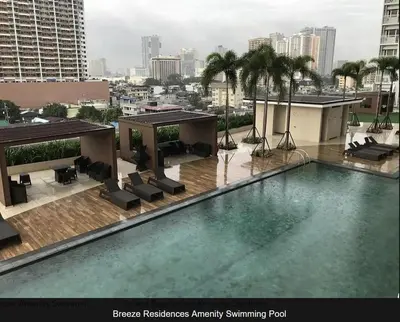 a swimming pool on top of a building at SMDC Breeze Residences in Manila