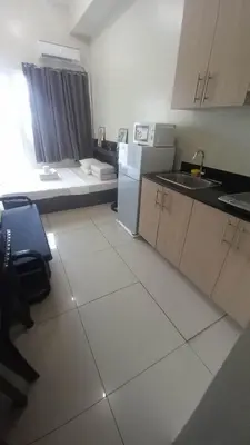 a small kitchen with a sink and a refrigerator at SMDC Breeze Residences in Manila
