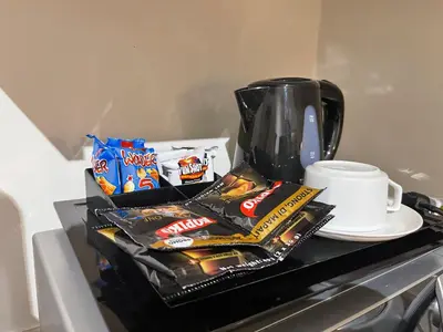 a counter with snacks and a coffee pot and a cup at Fabulous Skyline KL Greenbelt Makati in Manila
