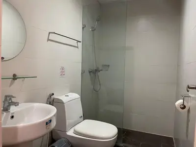 a bathroom with a shower and a toilet and a sink at Fabulous Skyline KL Greenbelt Makati in Manila