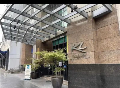 a building with a sign on the side of it at Fabulous Skyline KL Greenbelt Makati in Manila