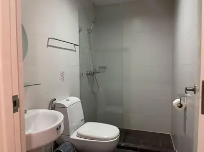 a bathroom with a shower and a toilet and a sink at Lux Skyline KL Greenbelt, Isabel's Makati Rooms in Manila