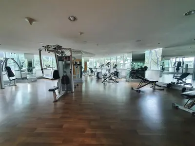 a gym with treadmills and machines in a room at Avant in BGC - Spacious 1 Bedroom with Amazing View in Manila