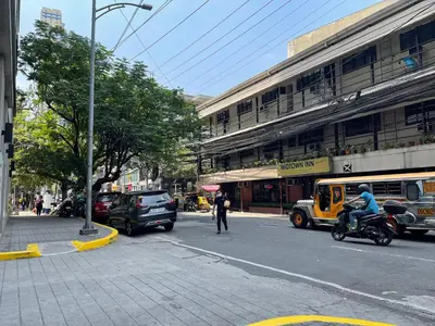 a person riding a motorcycle on a city street at Cozy Condo in Ermita Manila near St Lukes Medical Center and US Embassy in Manila