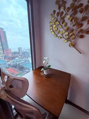 a table and a chair in a room with a window at 1 Bedroom Bayview Condo near SLMEC & US Embassy in Manila