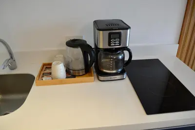 a coffeemaker sitting on top of a kitchen counter at Luxxe interior design condo - Residences at Acqua private residences in Manila