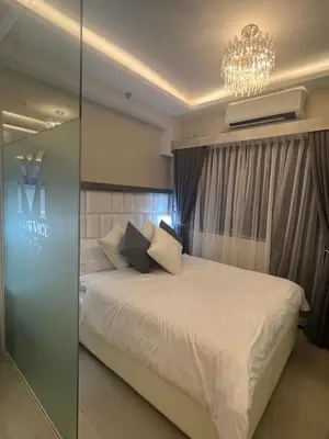 a bedroom with a bed and a chandelier at MiamiViceLuxuryStays at Shore2 in Manila