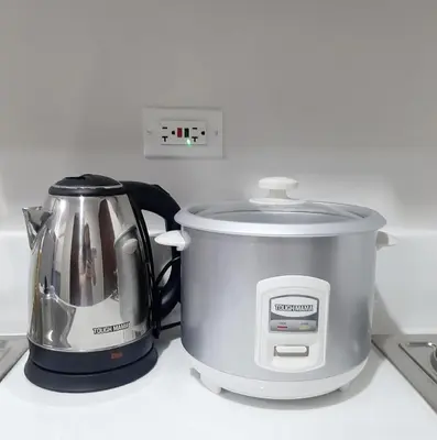 a slow cooker and a toaster on a counter at Air Residence Makati in Manila