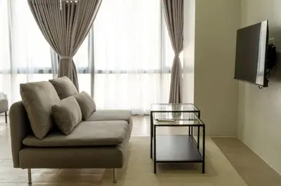 a living room with a couch and a glass table at StayHere Skandanavian Designed 1BR in Greenbelt in Manila