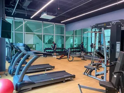 a gym with several tread machines in a room at Modern and homely Condo in Shaw Boulevard in Manila