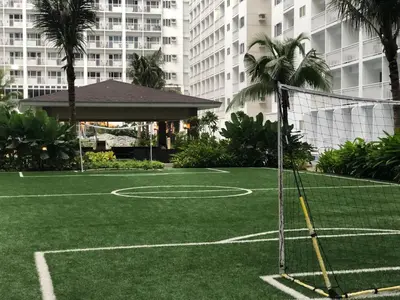 a basketball court in the middle of a city at Home at Last, 1 Bedroom Pool View with Balcony in Manila
