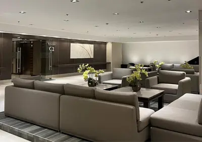 a lobby with couches and tables in a building at Victoria Suite at Shore Residences in Manila