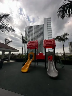 a playground with two slides and a slideintend at Chen's Cozy 2bedroom @ Coast Residences in Manila