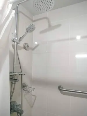a bathroom with a shower with a glass door at Cubao Manhattanheights U31N TB, Studio Unit in Manila