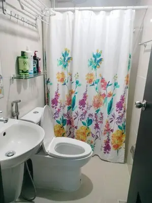 a bathroom with a toilet and a shower curtain at Cubao Manhattanheights U31N TB, Studio Unit in Manila