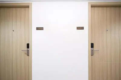 three doors in a room with signs on them at 2 Side-by-Side P00L Front Condos, 6 Beds, 2 CR, 2 Kitchen at MOA in Manila