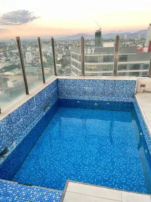 a swimming pool on the top of a building at Cozy Spacious Hotel Type Condo with PS5 Smart TV and WiFi in Manila