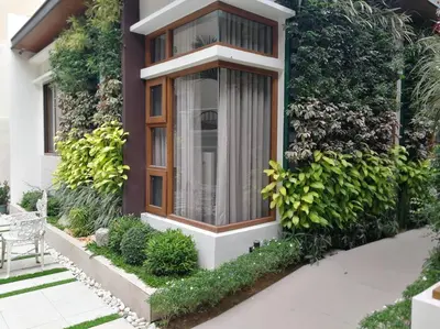 a house with a window and some plants at Adria Residences - Emerald Garden - 2 Bedroom Unit for 4 person in Manila