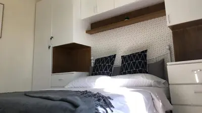 a bedroom with a bed with black and white pillows at Cozy 2BR corner unit in a prime location, your perfect city home in Manila