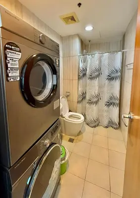 a washing machine in a bathroom with a toilet at 1 Bedroom Condo near US Embassy and St Lukes Medical Clinic in Manila