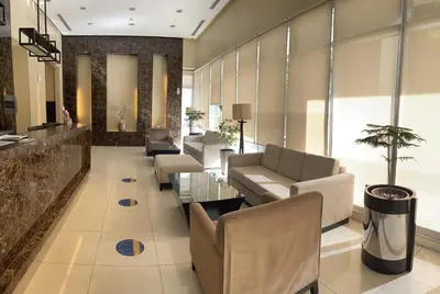a lobby with couches and chairs and a table at 1 Bedroom Condo near US Embassy and St Lukes Medical Clinic in Manila