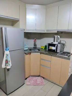 a kitchen with a refrigerator and a microwave at RQUI CONDOTEL in NAIA TERMINAL 3 at Two Palmtree Villas in Manila