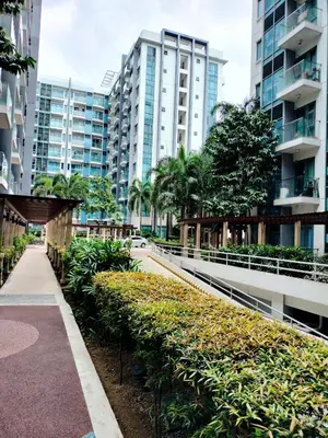 a walkway in a city with tall buildings at RQUI CONDOTEL in NAIA TERMINAL 3 at Two Palmtree Villas in Manila