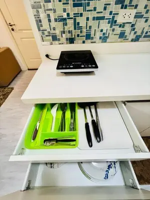 a white table with a laptop on top of it at Azure 2bedroom Condo With Balcony in Manila