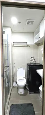 a bathroom with a toilet and a sink at Coast Residences - 2 Bedroom with Balcony facing Mall of Asia, Manila Bay & Pool View in Manila