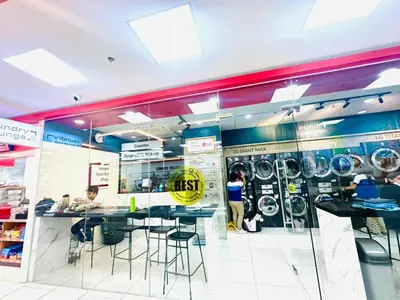 a fast food restaurant with a counter and stools at Coast Residences - 2 Bedroom with Balcony facing Mall of Asia, Manila Bay & Pool View in Manila