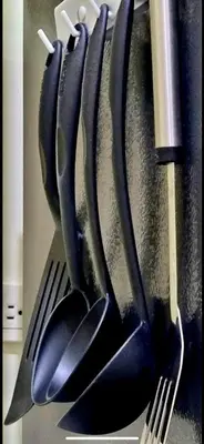 a bunch of utensils hanging on a wall at Field Residence SMDC 1BR w/ Netflix in Manila