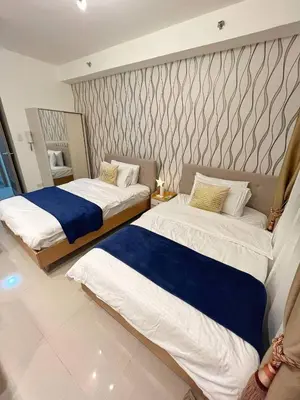 a bedroom with two beds and a wall at M&M Condostay at Shore 2 Residences Tower 2 Pasay City in Manila