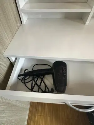a black appliance sitting on top of a shelf at TriG Place at Grace Residence in Taguig City in Manila