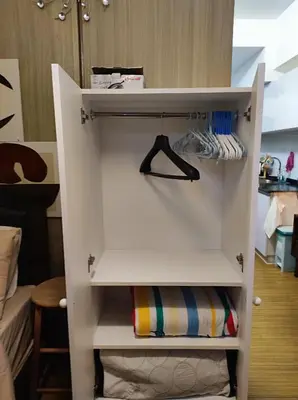 a white cupboard with a shelf in a room at TriG Place at Grace Residence in Taguig City in Manila