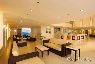 a large living room with couches and a kitchen at Elresa Elegant at Field Residences Condominium Hotel in Manila