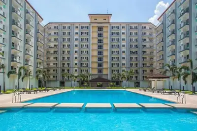a large apartment building with a large swimming pool at Elresa Elegant at Field Residences Condominium Hotel in Manila