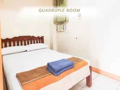 a bedroom with a bed with a blue towel on it at Cenco Suites Residences - Transient in Tanza Cavite in Tanza