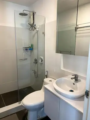 a bathroom with a toilet and a sink and a shower at Modern Condo Apt in Flair Tower South, Mandaluyong in Manila