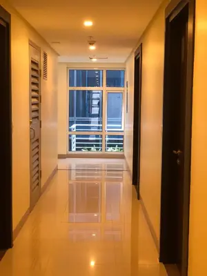 a hallway with a large window in a building at 101 Newport Boulevard-Favila Condotel Unit near Airport in Manila