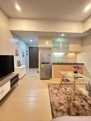 a large kitchen with a table and a tv at EJ's Staycation 4th F with 200mbps Wi-Fi and NETFLIX in Manila